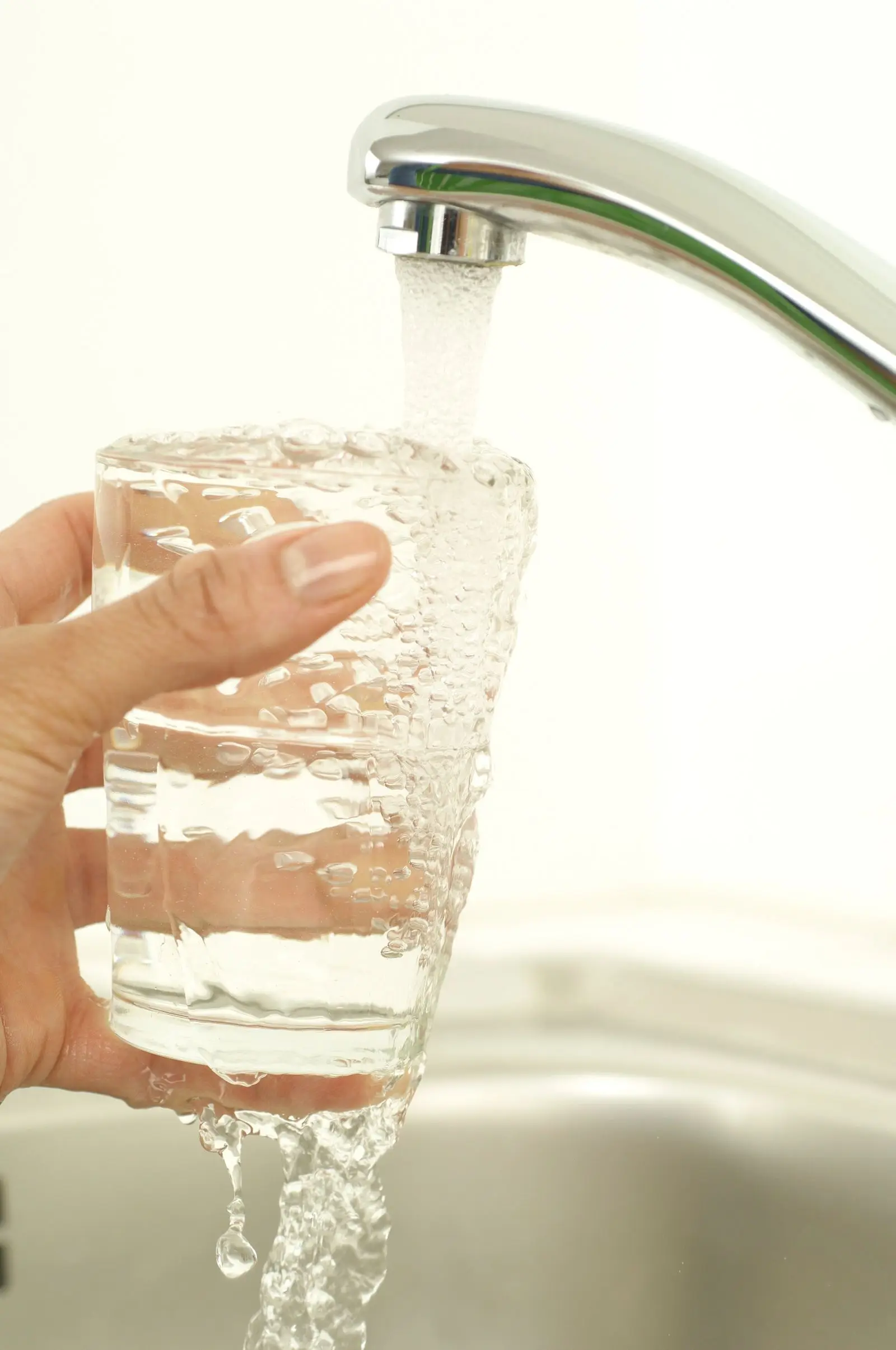 Filling a glass with tap water
