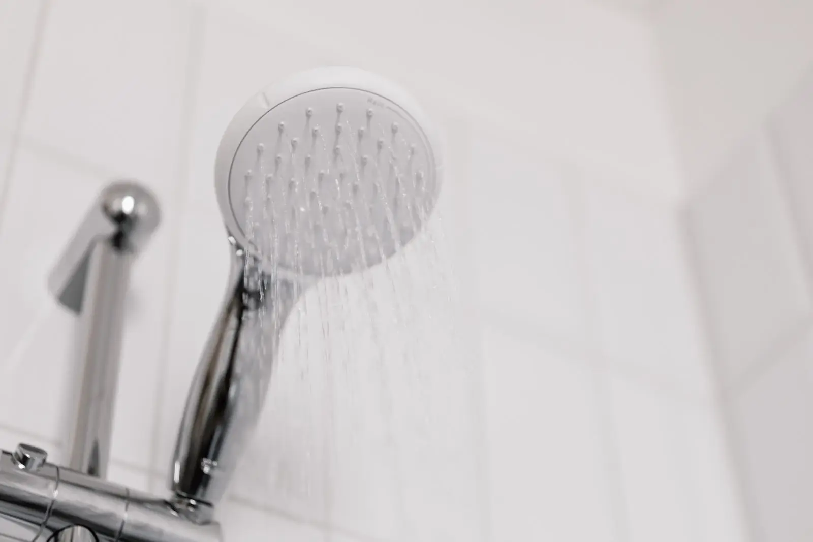 Shower head running hot water